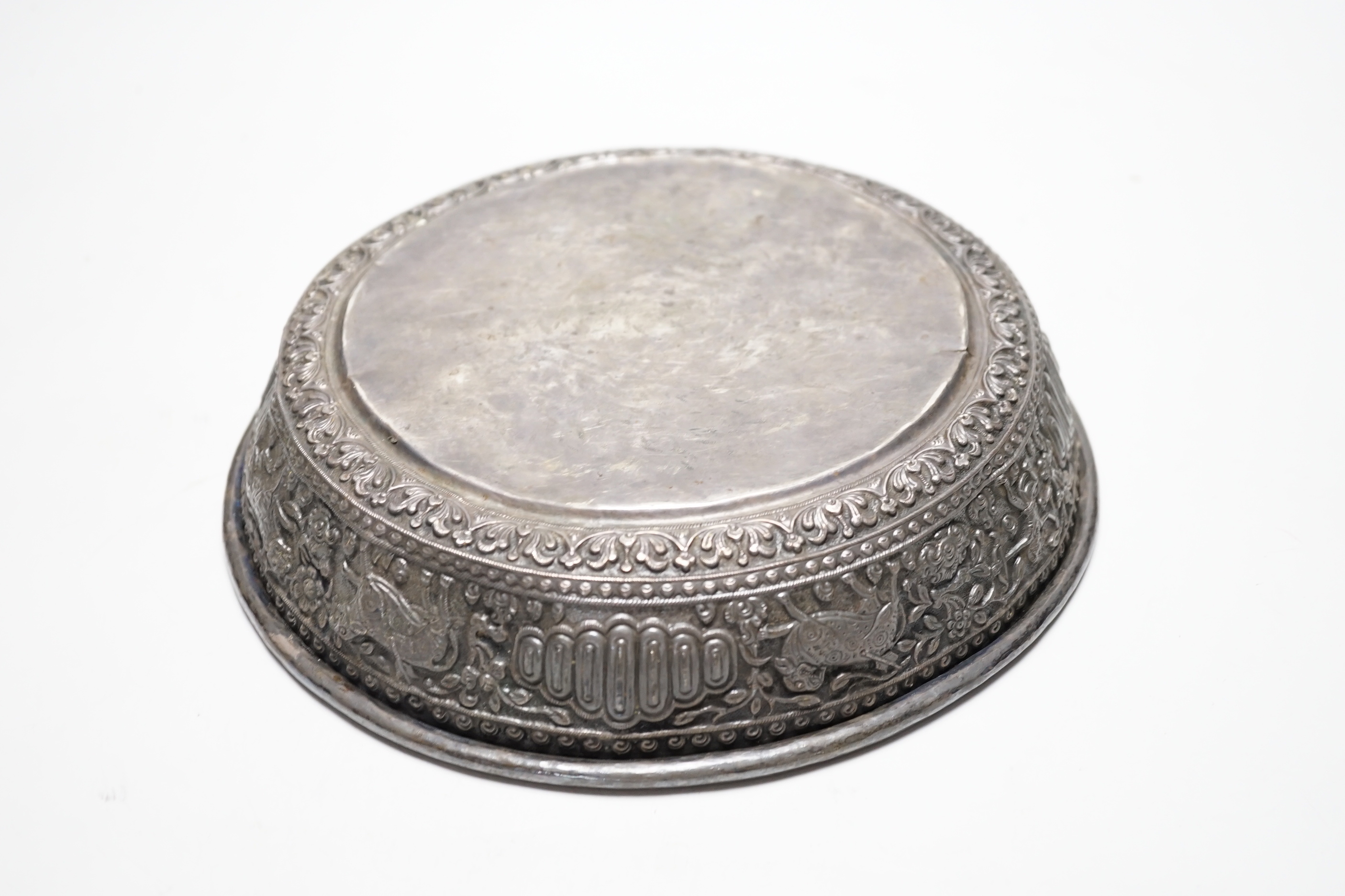 An Asian embossed white metal (tests as silver) shallow bowl, 25.2cm, 13.5oz.